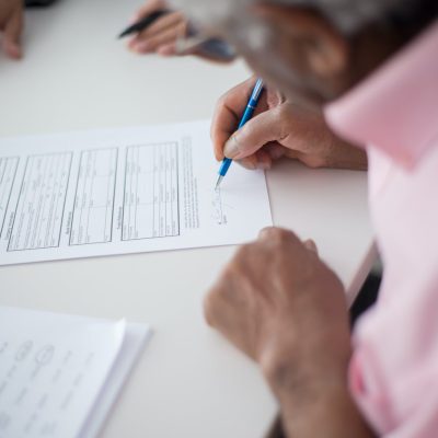 Person Writing on White Paper